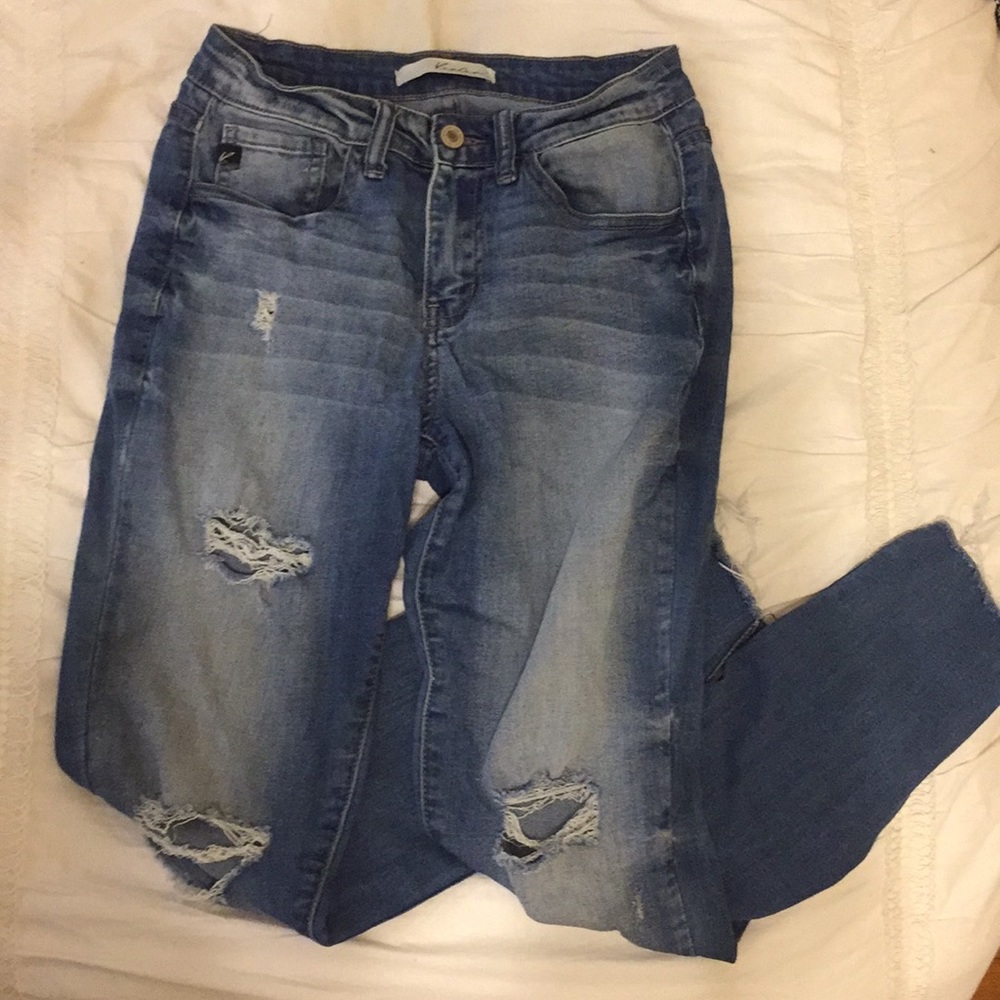 Distressed blue denim jeans